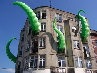 Illustration for article titled Giant Green Tentacles Attack Buildings from the Inside